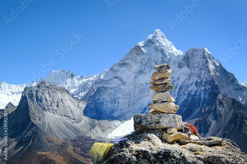 Cairns on a hill with a view of Ama Dablam on the way to Everest Base Camp. Khumbu valley, Nepal © Andrii Vergeles