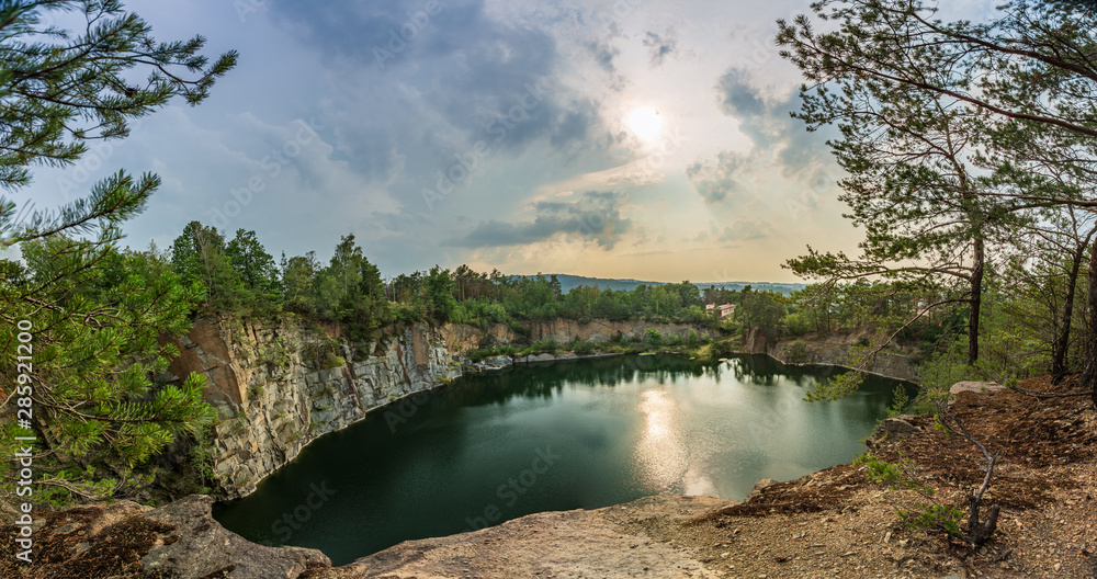 Beautiful landscape, quarry with blue and green water, wonderful view, sunset, under cloud.