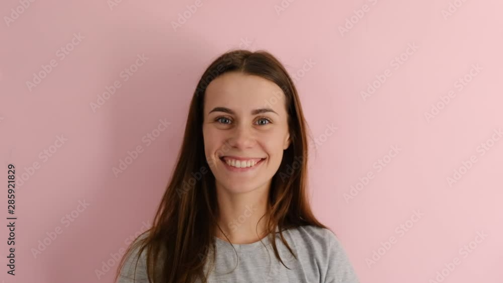 Positive european woman makes okay gesture, wears gray T-shirt, enjoys life, isolated over pink background, says ok, confirms information. Its excellent result Positive european woman makes okay gesture, wears gray T-shirt, enjoys life, isolated over pink background, says ok, confirms information. Its excellent result