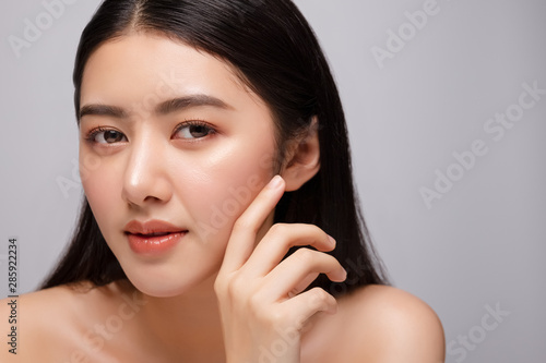 Portrait of beautiful young asian woman clean fresh bare skin concept. Asian girl beauty face skincare and health wellness  Facial treatment  Perfect skin  Natural make up. Isolated on gray background