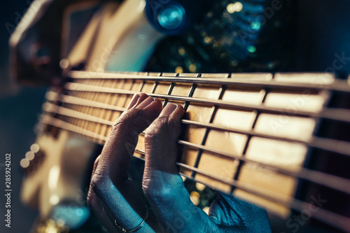 Closeup photo of bass guitar player hands