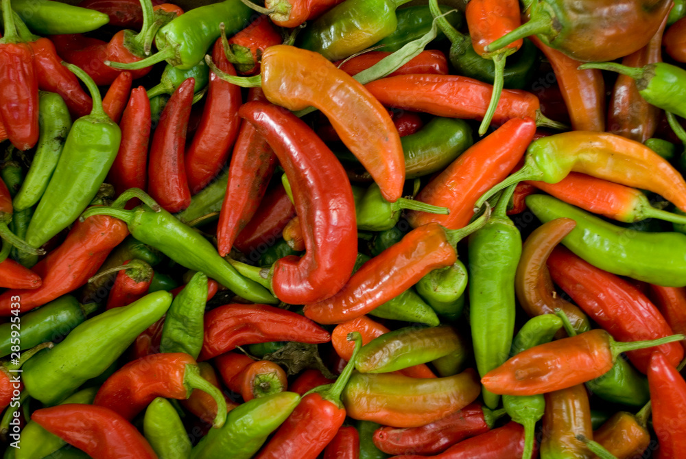 varieties of peppers, red, green, orange, thin, used as spices or grilled, at local vegetable market, agriculture, food, vitamins, nourishment, summer, background, Milan, Italy varieties of peppers, red, green, orange, thin, used as spices or grilled, at local vegetable market, agriculture, food, vitamins, nourishment, summer, background, Milan, Italy