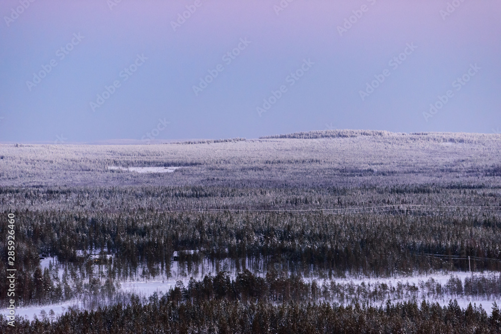 Obraz premium The landscape forest has covered with heavy snow and sunset sky from top view landscape in winter season at Lapland, Finland.