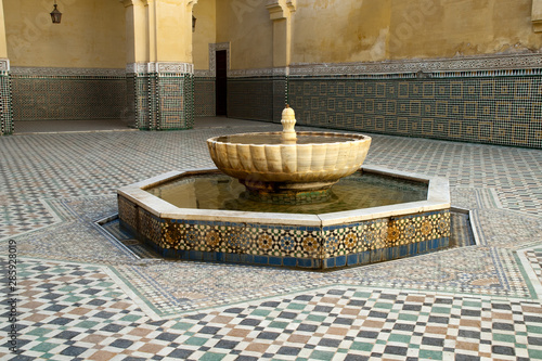 Meknes Morocco, fountain and zellige tilework in courtyard at Mausoleum of Moulay Ismail photo