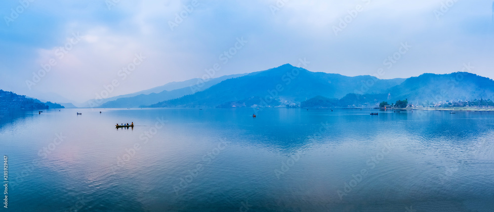 Boats on Phewa lake. Wide angle landscape. Pokhara, Nepal.