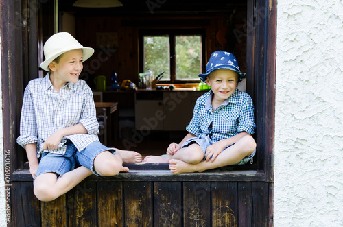 Small boys having fun in the window