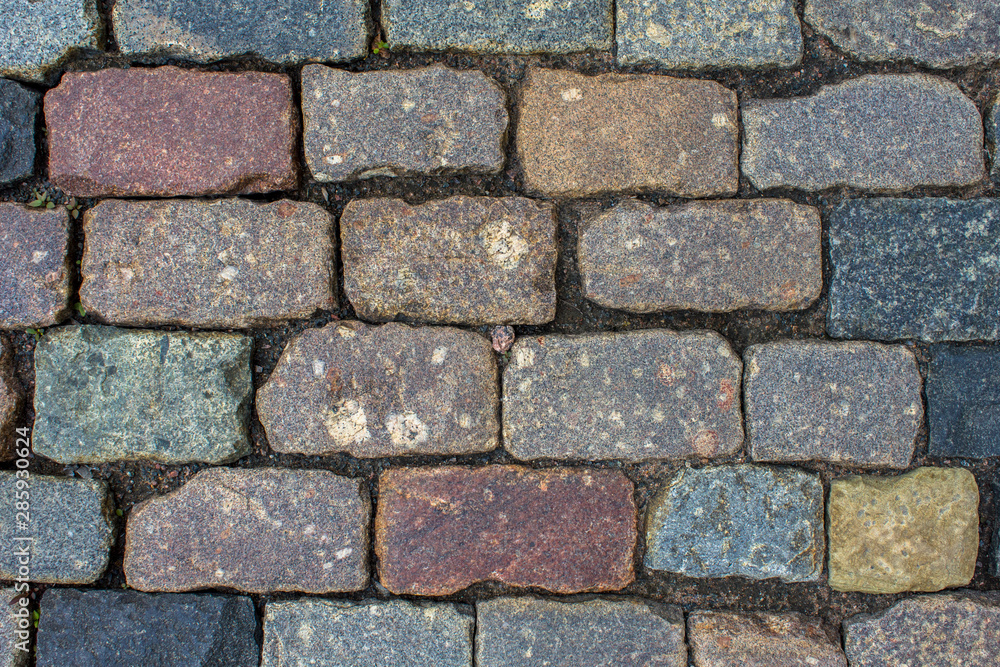 ancient stone wall of bricks of various shapes, sizes and colors. rough surface texture ancient stone wall of bricks of various shapes, sizes and colors. rough surface texture