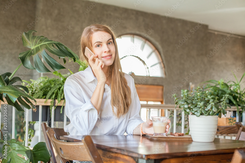 Business woman with smartphone working in open office place Business woman with smartphone working in open office place