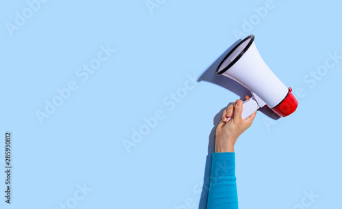 Person holding a megaphone with hard shadow