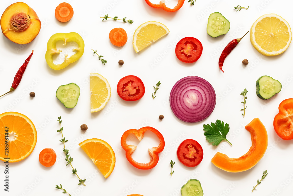 Flat lay slices of vegetables and fruits on a white background, isolated. View from above Flat lay slices of vegetables and fruits on a white background, isolated. View from above