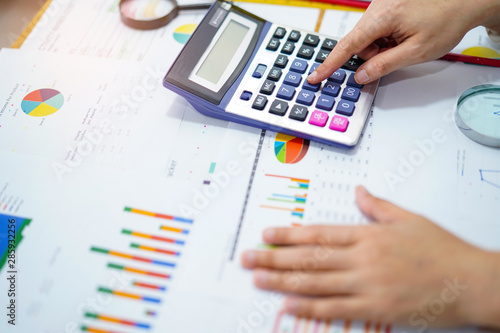 Accountant working project accounting with graph in modern office.