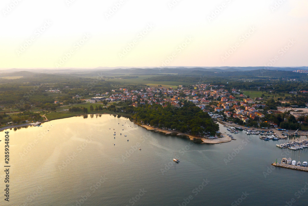 Sunrise over a small town. The city is located on the beach. Istria Peninsula, Croatia. Copy space.