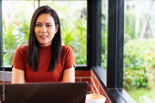 Asia woman hands typing on laptop keyboard. Woman working at office with coffee