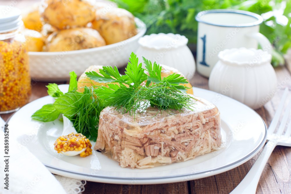 Homemade Aspic of turkey meat on a white plate with boiled potatoes, horizontal Homemade Aspic of turkey meat on a white plate with boiled potatoes, horizontal