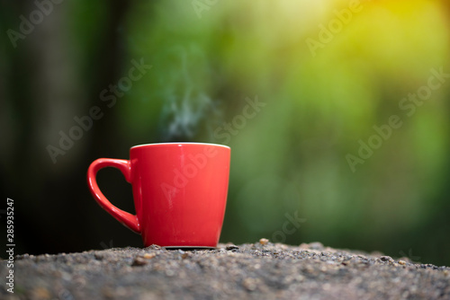 Red cup of coffee with natore background