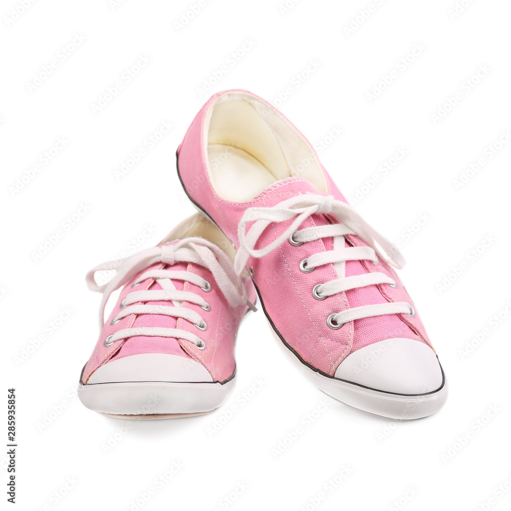 Pair of pink female sneakers isolated on white