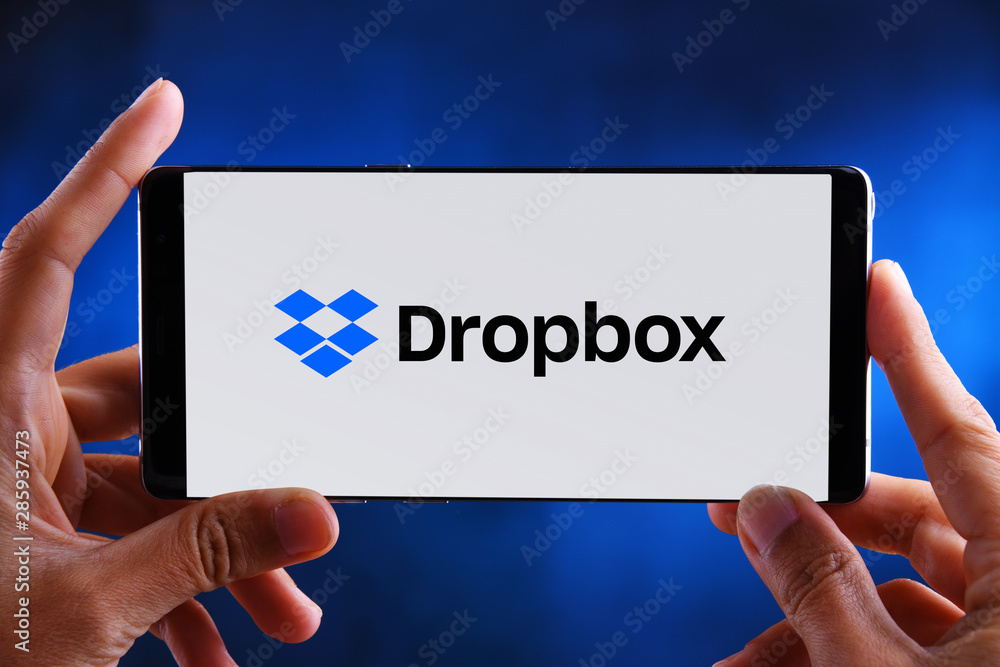 Hands holding smartphone displaying logo of Dropbox Stock Photo | Adobe  Stock