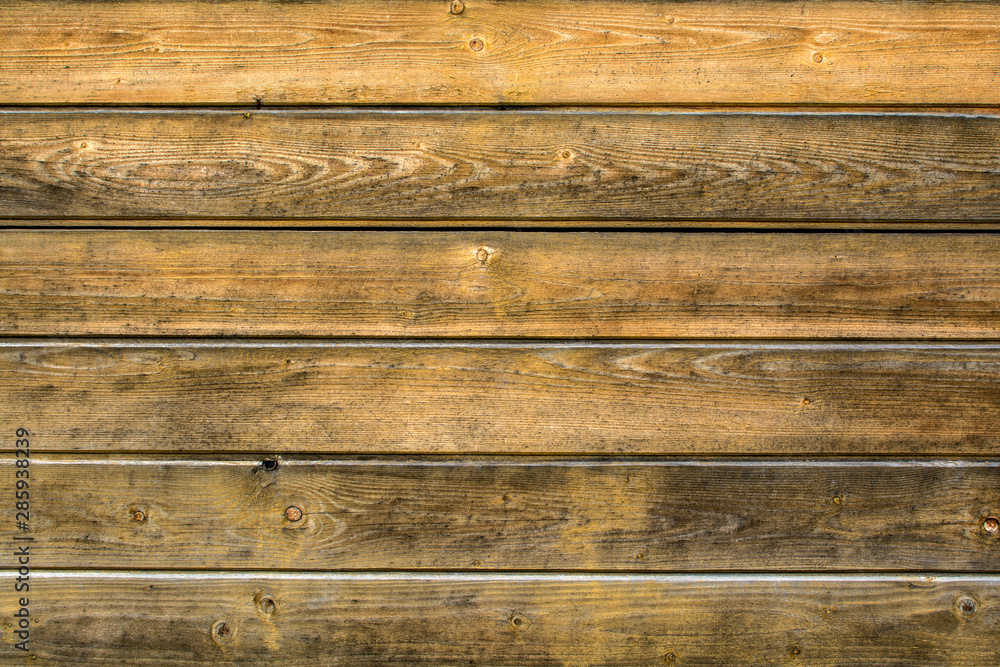 Naklejka premium Background from old, shabby light brown boards arranged horizontally with space for text.