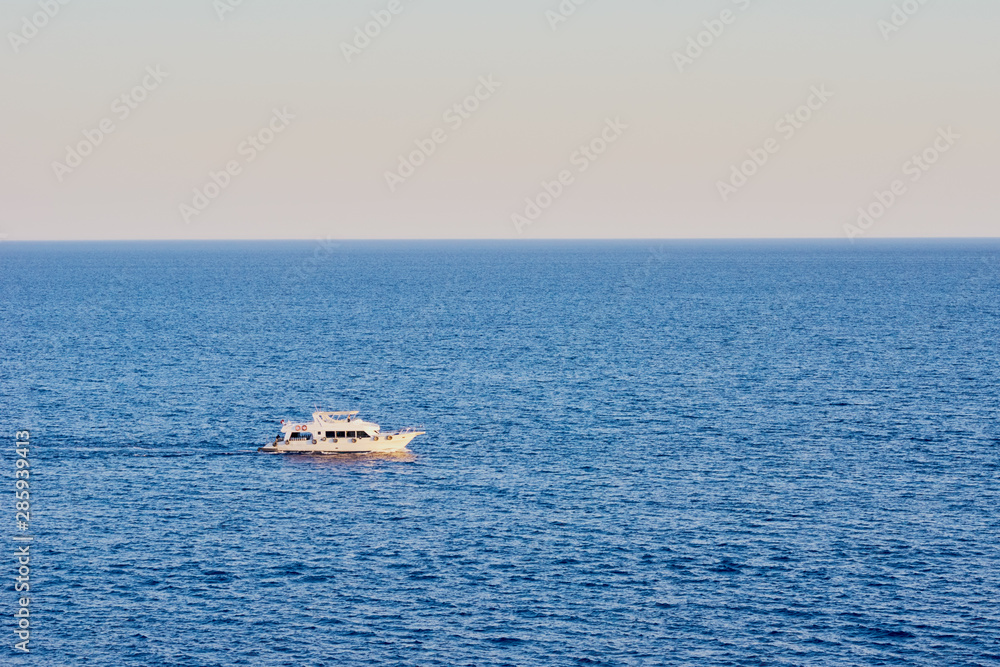 Trolling boat in a blue water of ocean