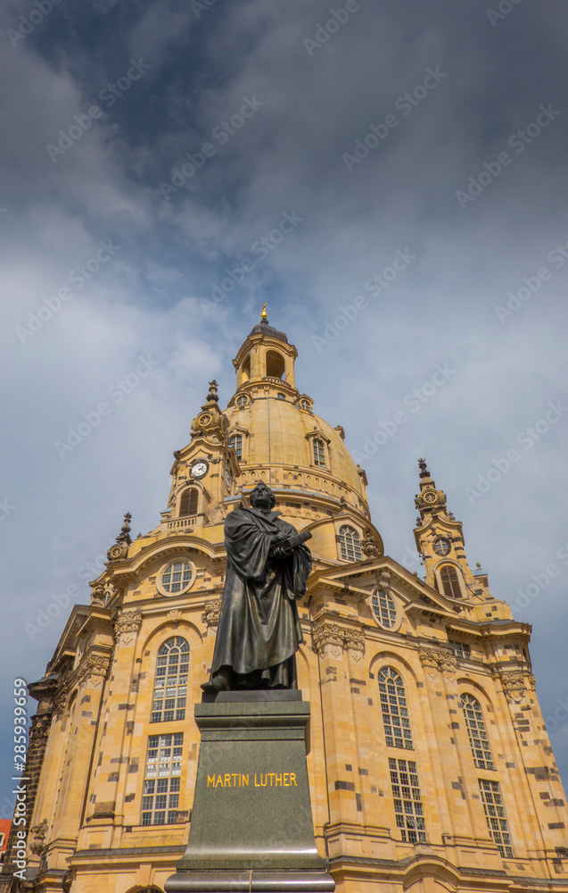 Dresden, Saxony, Germany. State of reformer Martin Luther in front of the Frauenkirche which which was rebuilt after the II. World War