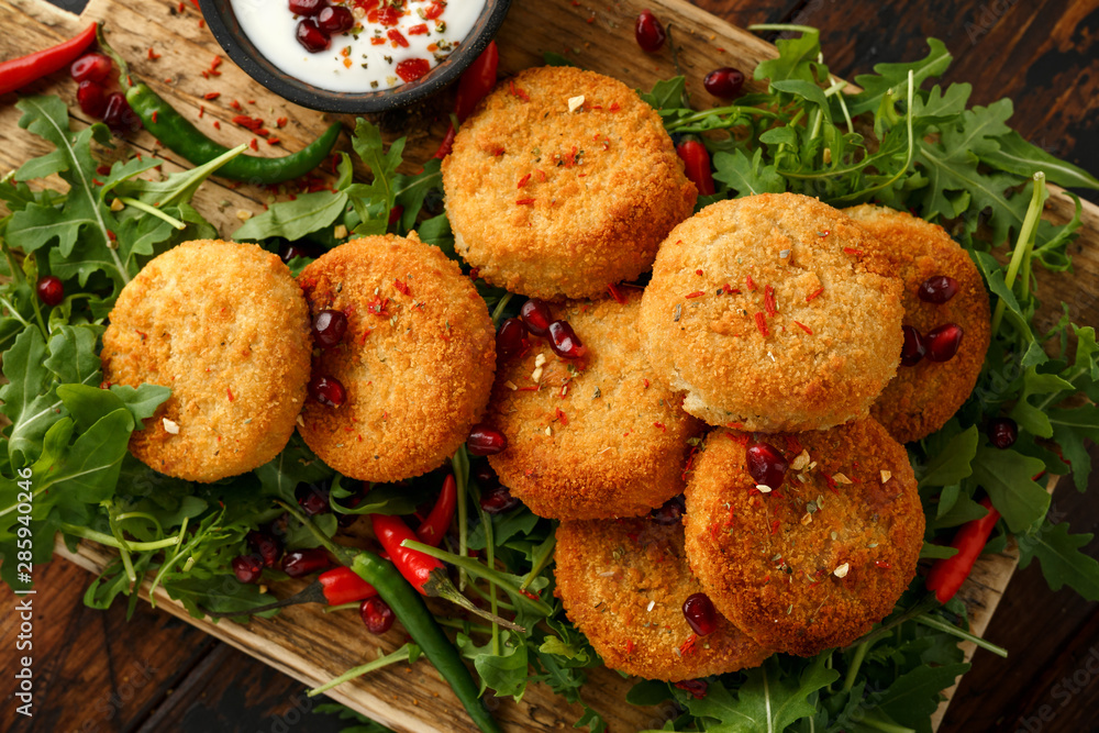 Wall Mural Thai food spicy fish cakes served with pomegranate seeds and wild rocket, arugula salad