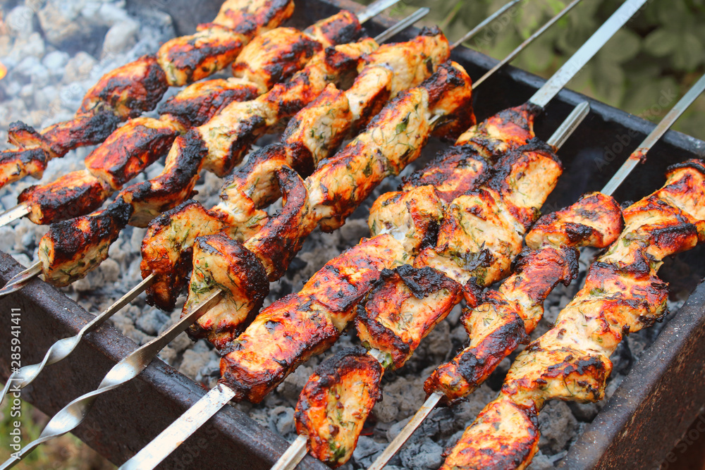 Hot meat skewers on the grill. Close-up. Background.