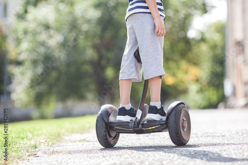 Cute little boy driving segway. Child skating on hyroboard. Boy driving hover. photo