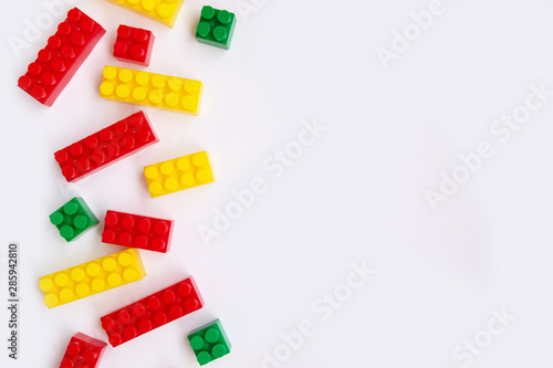 Multi-colored Plastic building blocks isolated on white background, Top view with copy space © Анна Кадулина