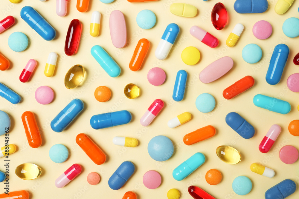 Many different pills on color background, top view Many different pills on color background, top view
