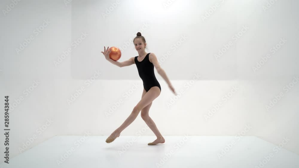 A girl gymnast performs exercises with a mace. A girl gymnast performs exercises with a mace.