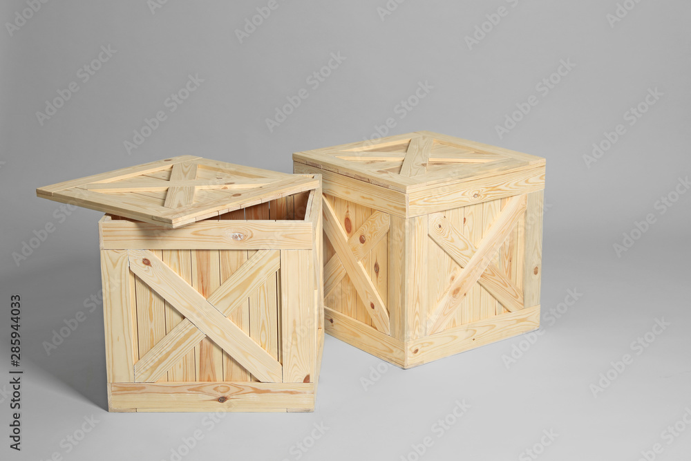 Pair of wooden crates on grey background Pair of wooden crates on grey background