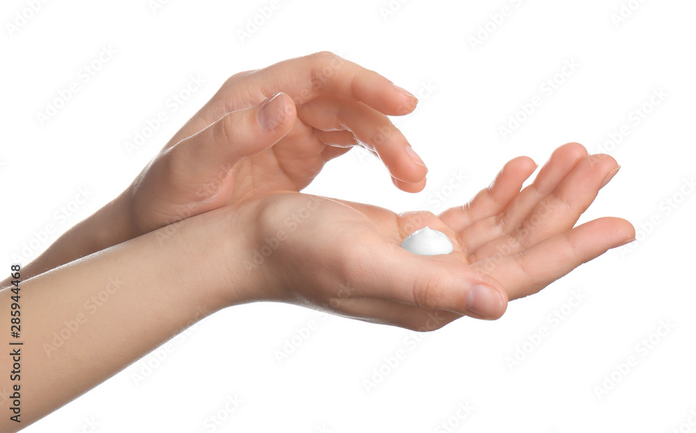 Woman applying cream onto hands isolated on white, closeup