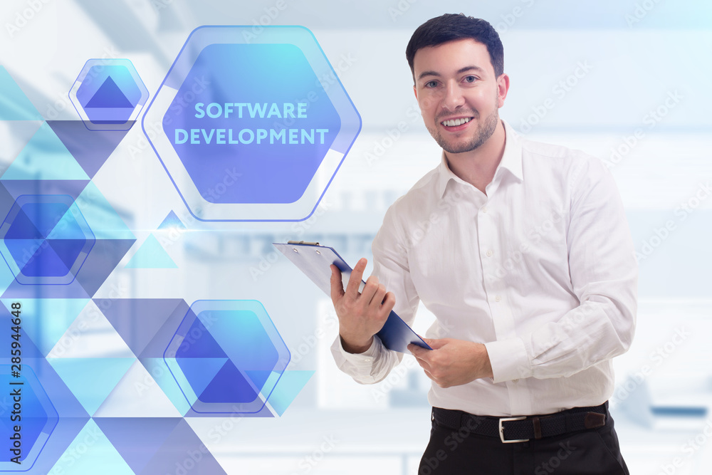 The concept of business, technology, the Internet and the network. A young entrepreneur working on a virtual screen of the future and sees the inscription: Software development