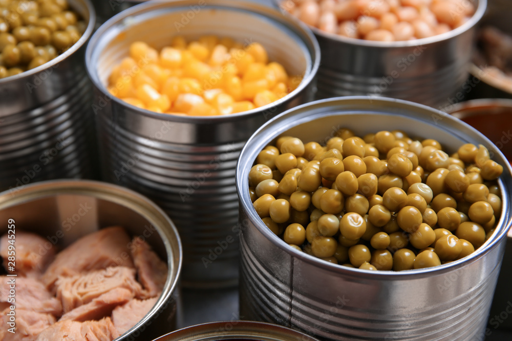 Open tin cans with conserved products, closeup Open tin cans with conserved products, closeup
