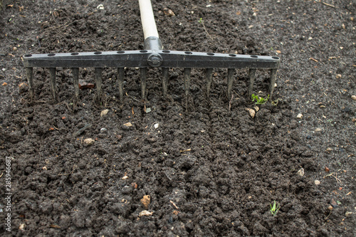 Loosening the excavated ground with a rake close-up