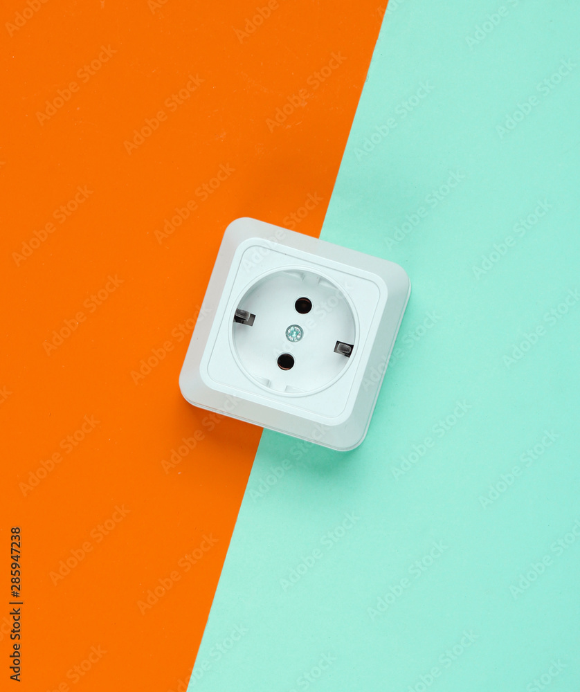 White plastic power socket on colored background. Minimalism White plastic power socket on colored background. Minimalism