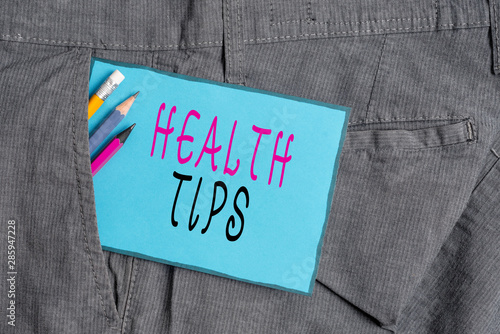 Conceptual hand writing showing Health Tips. Concept meaning advice or information given to be helpful in being healthy Writing equipment and blue note paper in pocket of trousers