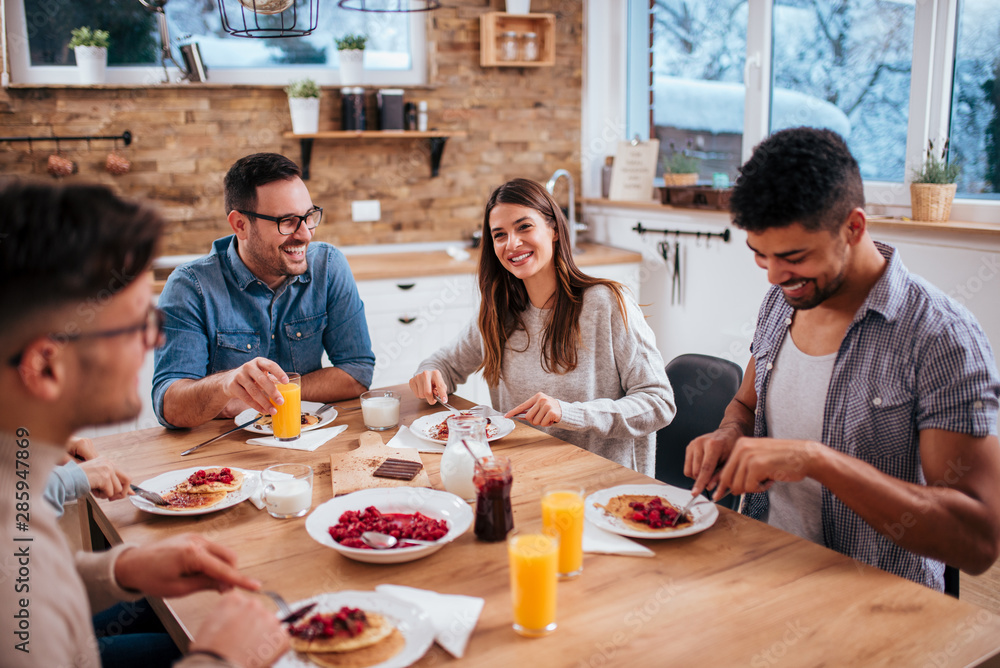 Good morning. Roommates eating breakfast talking at home in the morning. Good morning. Roommates eating breakfast talking at home in the morning.