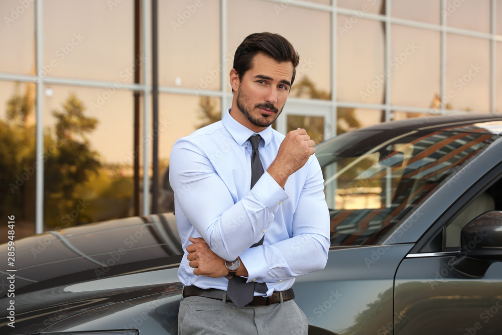 Attractive young man near luxury car outdoors Attractive young man near luxury car outdoors