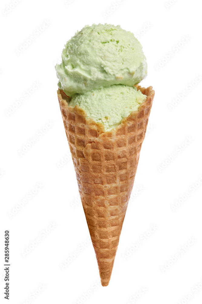 Waffle cone with sweet pistachio ice cream on white background Waffle cone with sweet pistachio ice cream on white background