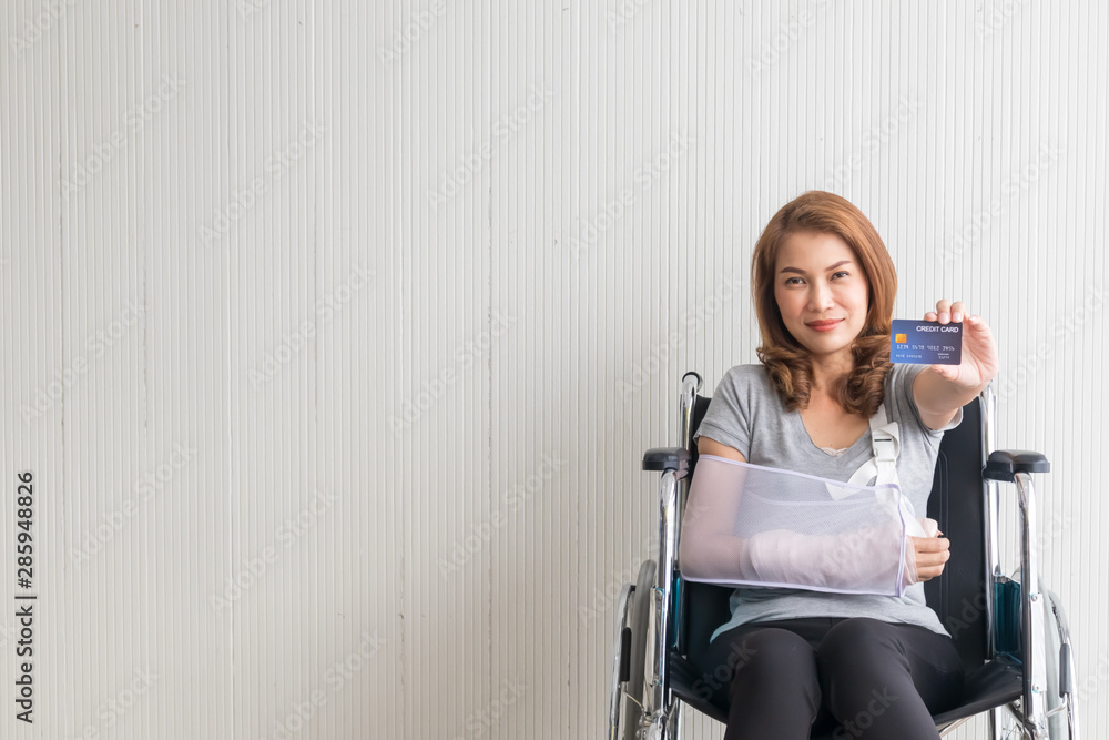 Female patients with broken arms, wheelchair women holding credit cards