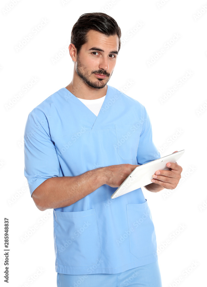 Young male doctor in uniform with tablet on white background. Medical service Young male doctor in uniform with tablet on white background. Medical service