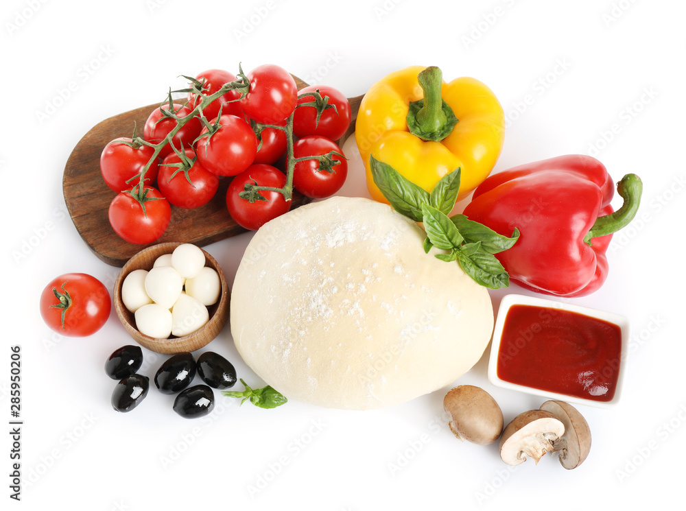 Fresh dough and ingredients for pizza on white background, top view