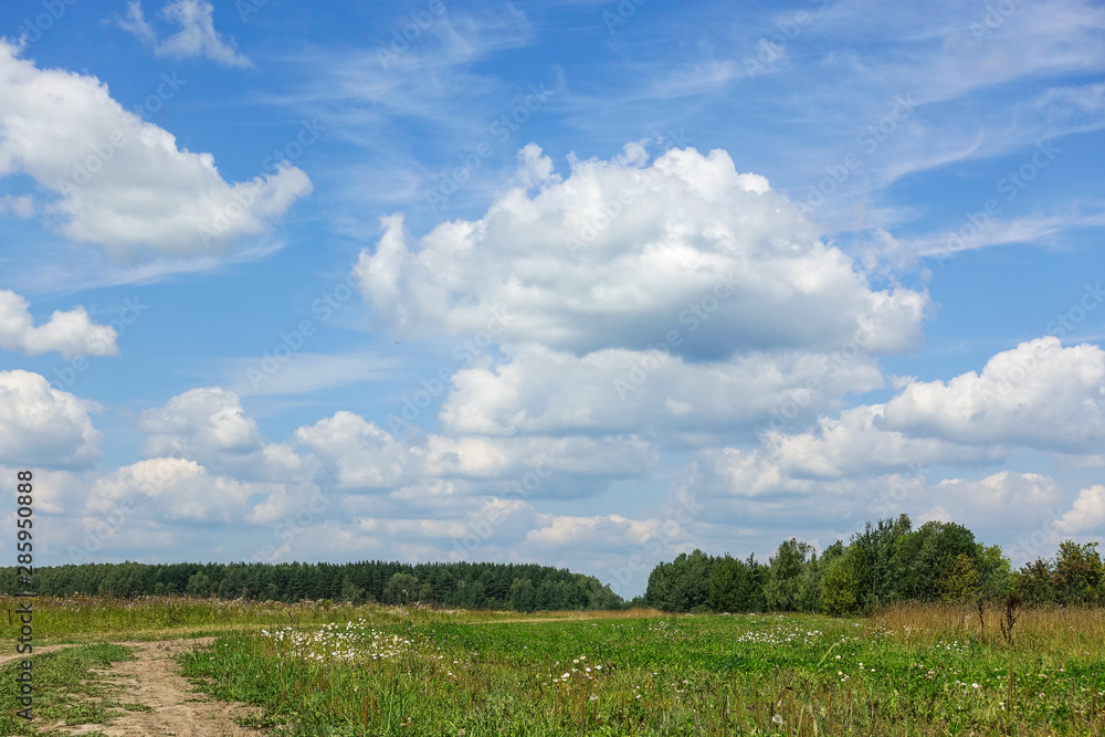 Country road and green grass and cloud sky. Russia Country road and green grass and cloud sky. Russia