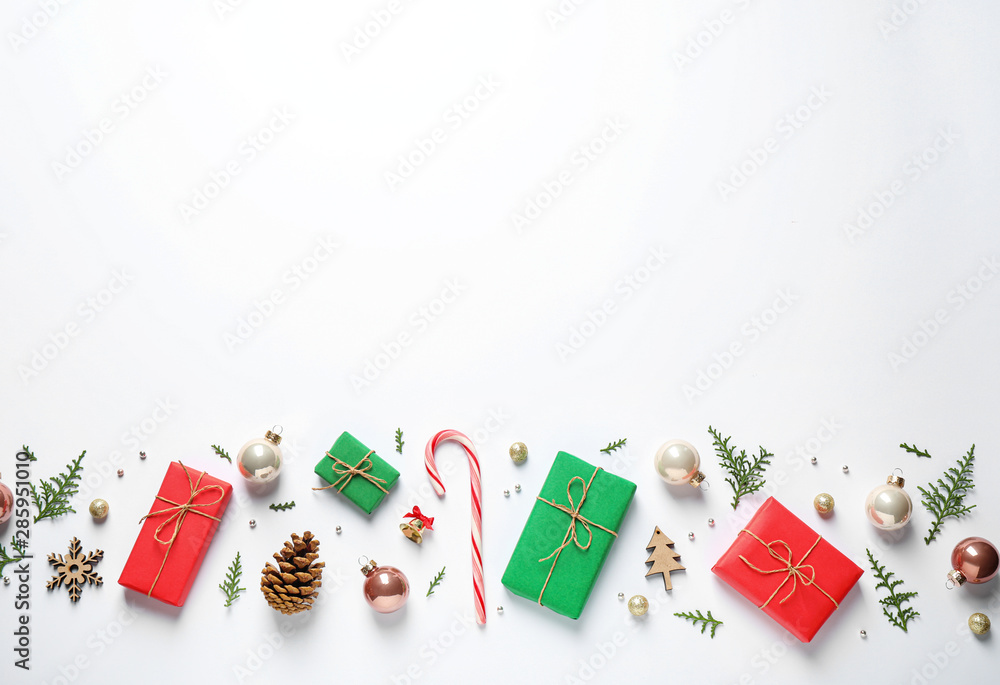 Flat lay composition with Christmas gifts and festive decor on white background. Space for text Flat lay composition with Christmas gifts and festive decor on white background. Space for text
