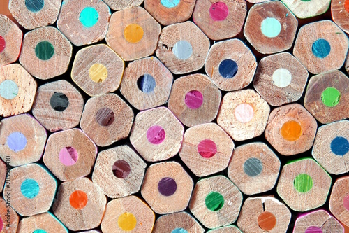 Wooden multicolored pencils all colors. Colored pencils stacked in rows on top of each other. frame of colored circles background abstract pattern. Office, Education projects, back to school Concept
