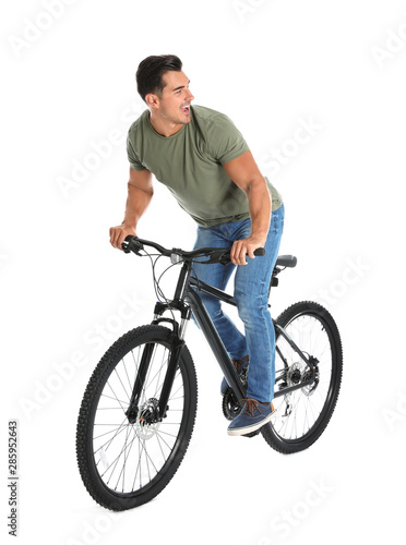 Handsome young man with modern bicycle on white background