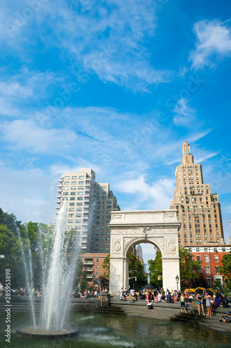 People cool off on a hot summer day at the Washington Square Park fountain, which was moved in 2009 to better align with the arch.