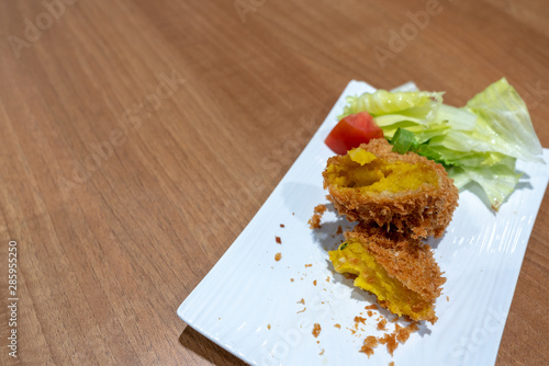 Japanese Crunchy Fried, Hokkaido Pumpkin Croquette on plate in restaurant. photo