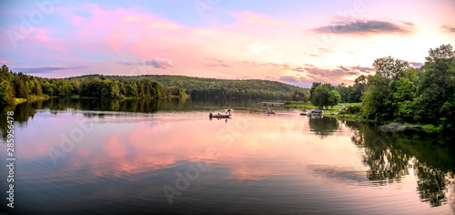 Sunset on lake with boat © Martina